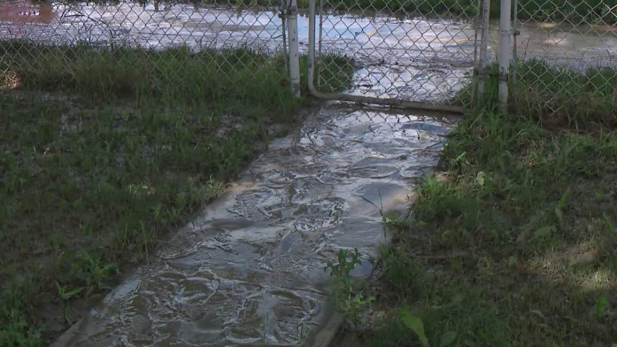 Thick mud covers properties in the area of 101 Street and 116 Avenue in Edmonton Monday, July 5, 2021, one day after a water main break in the area.