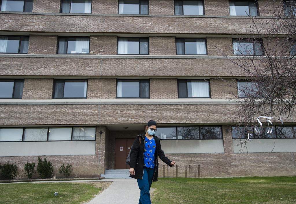 A health care worker leaves after finishing her shift for the day at the Eatonville Care Centre in Toronto on Friday, April 24, 2020. THE CANADIAN PRESS/Nathan Denette.