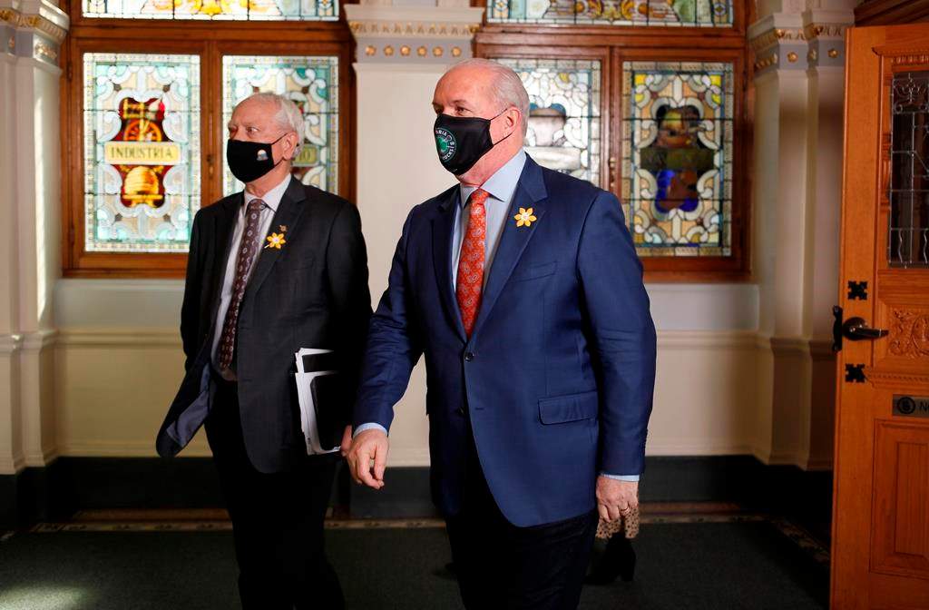 Minister of Indigenous Relations and Reconciliation Murray Rankin, left, and Premier John Horgan leave the chamber at the Legislature in Victoria, B.C., on April 12, 2021. THE CANADIAN PRESS/Chad Hipolito.