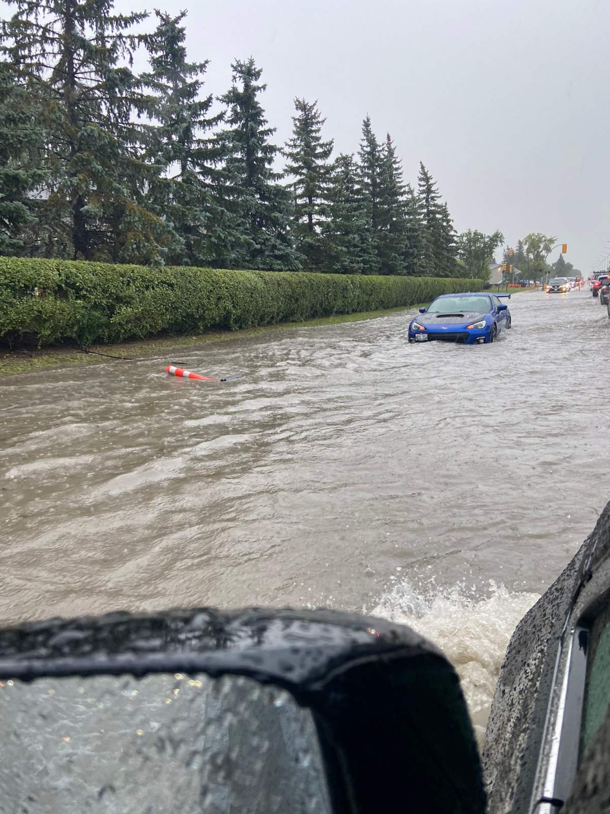 Cars barely made it down Brandt Street in Steinbach Friday afternoon during substantial rainfall.