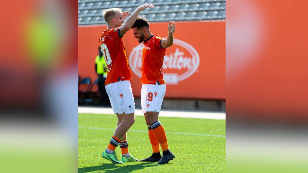 Kyle Bekker and Tristan Borges celebrate a Forge FC goal during a match against York United on Saturday Aug. 28, 2021.