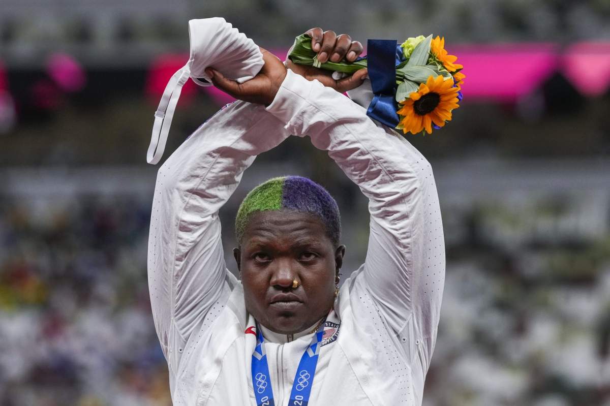 Raven Saunders, of the United States, poses with her silver medal on women's shot put at the 2020 Summer Olympics, Sunday, Aug. 1, 2021, in Tokyo, Japan.  During the photo op at her medals ceremony Sunday night, Saunders stepped off the podium, lifted her arms above her head and formed an “X’ with her wrists. Asked what that meant, she explained: ”It’s the intersection of where all people who are oppressed meet.” (AP Photo/Francisco Seco).