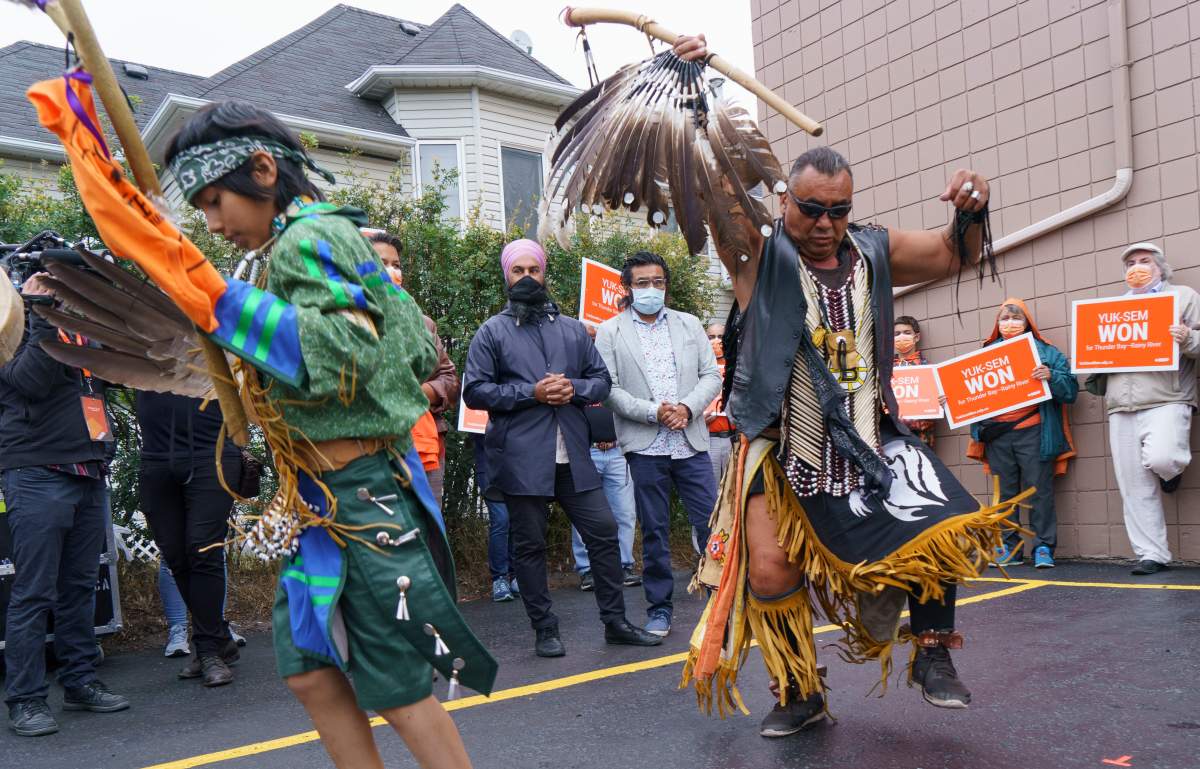 NDP Leader Jagmeet Singh watches indigenous traditional dancers perform during a campaign stop in Thunder Bay, Ont., Friday, Aug. 27, 2021.
