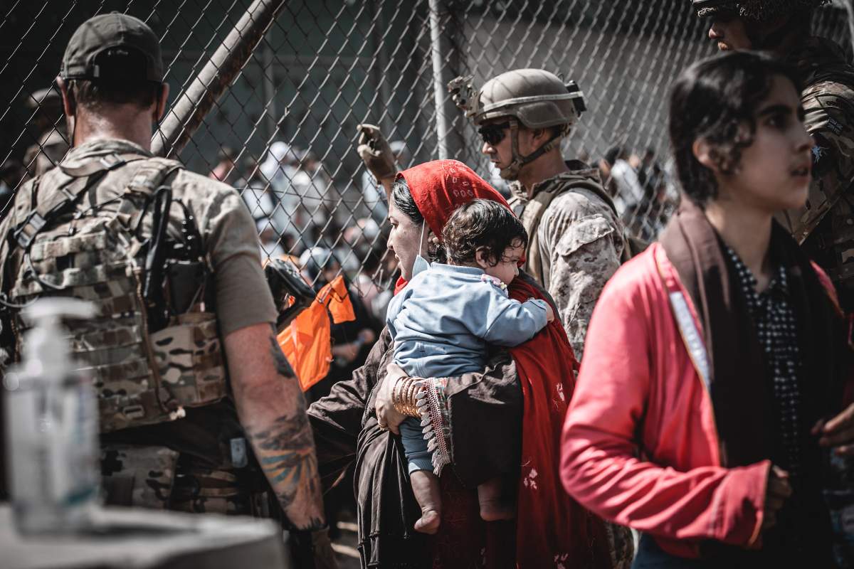 Evacuees await their departure during evacuation operations at Hamid Karzai International Airport, Kabul, Afghanistan, on Aug. 22 in the days following the fall of Kabul to Taliban movement, amid chaos and panic scenes at the capital’s airport.