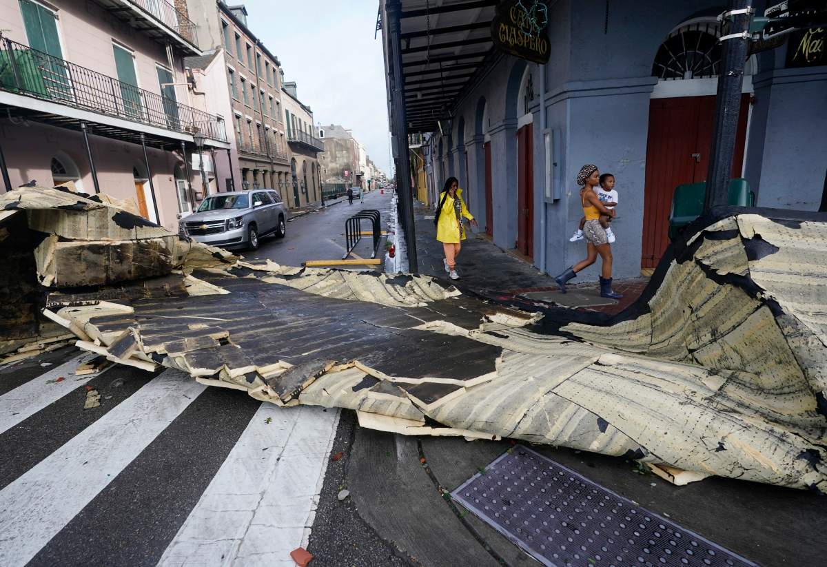 A section of roof that was blown off of a building in the French Quarter by Hurricane Ida winds blocks an intersection, Monday, Aug. 30, 2021, in New Orleans, La. (AP Photo/Eric Gay)