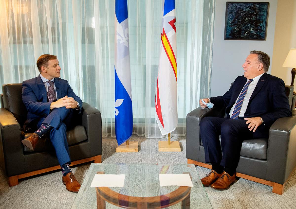 Quebec Premier Francois Legault, right, speaks with Newfoundland and Labrador Premier Andrew Furey during a meeting in Montreal, Monday, August 30, 2021.
