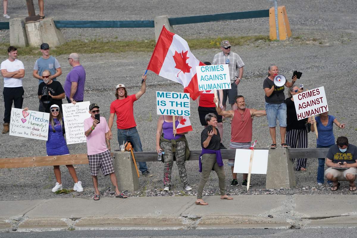 Anti-vaccine protestors shout obscenities at Liberal Leader Justin Trudeau during his visit to the University of Sudbury in Sudbury, Ontario on Tuesday, August 31, 2021.