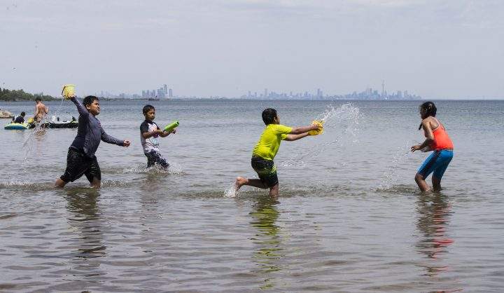 Children have a water fight at Lake Ontario in Mississauga on June 5, 2021.
