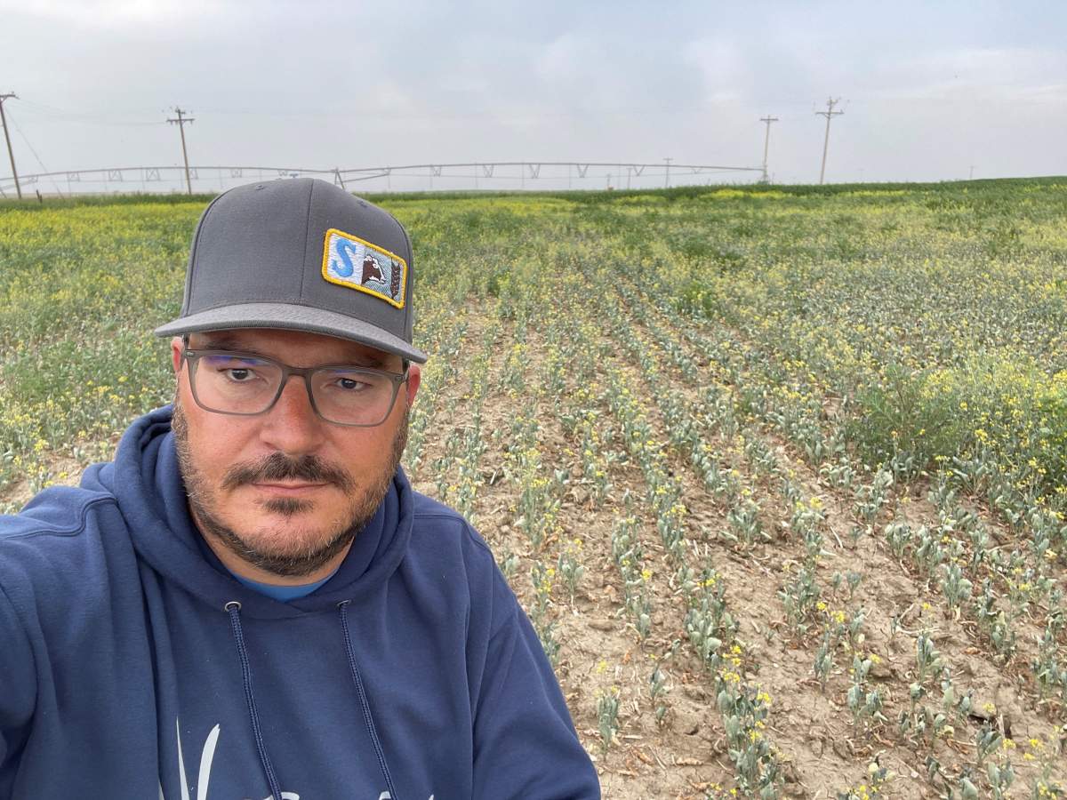Kevin Serfas in front of his crops in Turin, Alta.