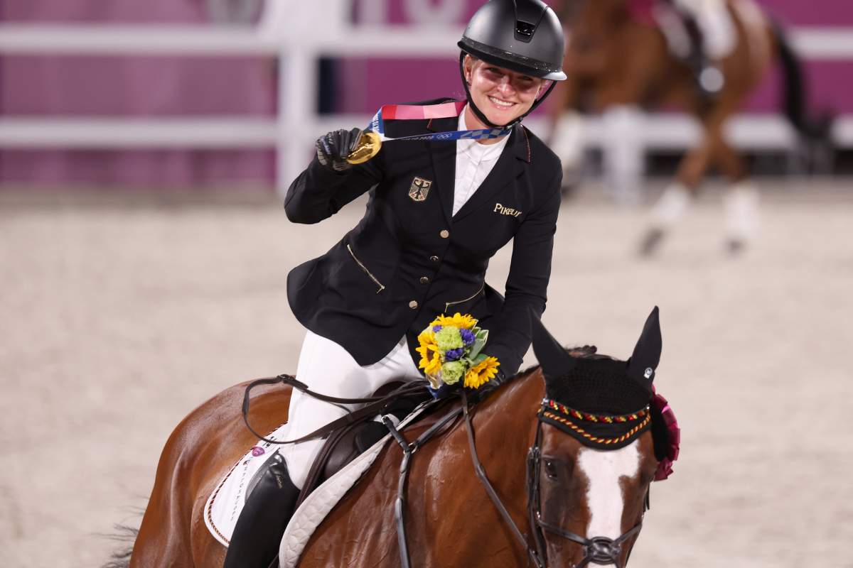 Gold medallist Julia Krajewski from Germany rides a lap of honour on Amande de B`Neville after becoming the first female Olympic eventing champion.