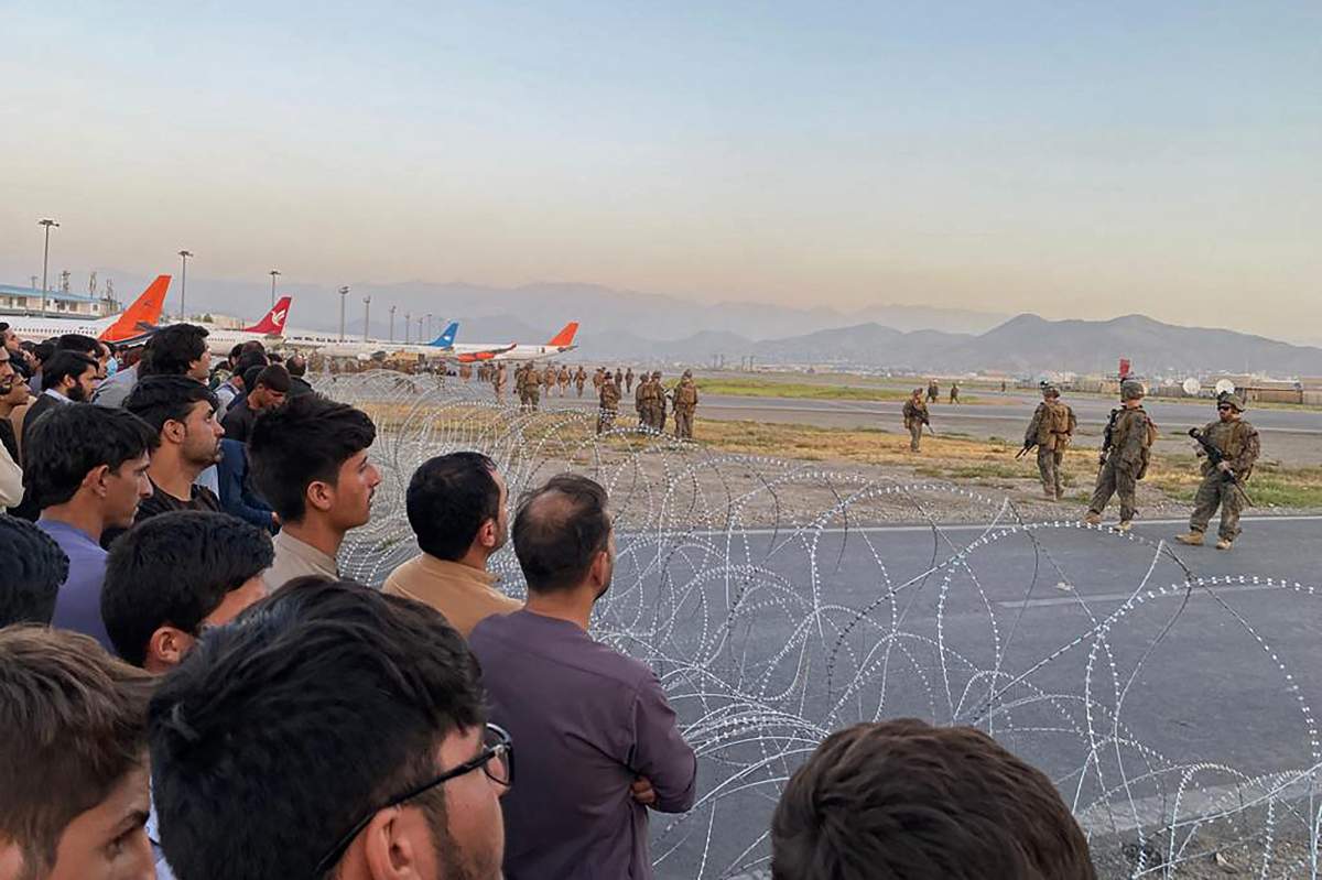 7 dead after thousands pack Kabul airport trying to flee Afghanistan amid Taliban takeover - image