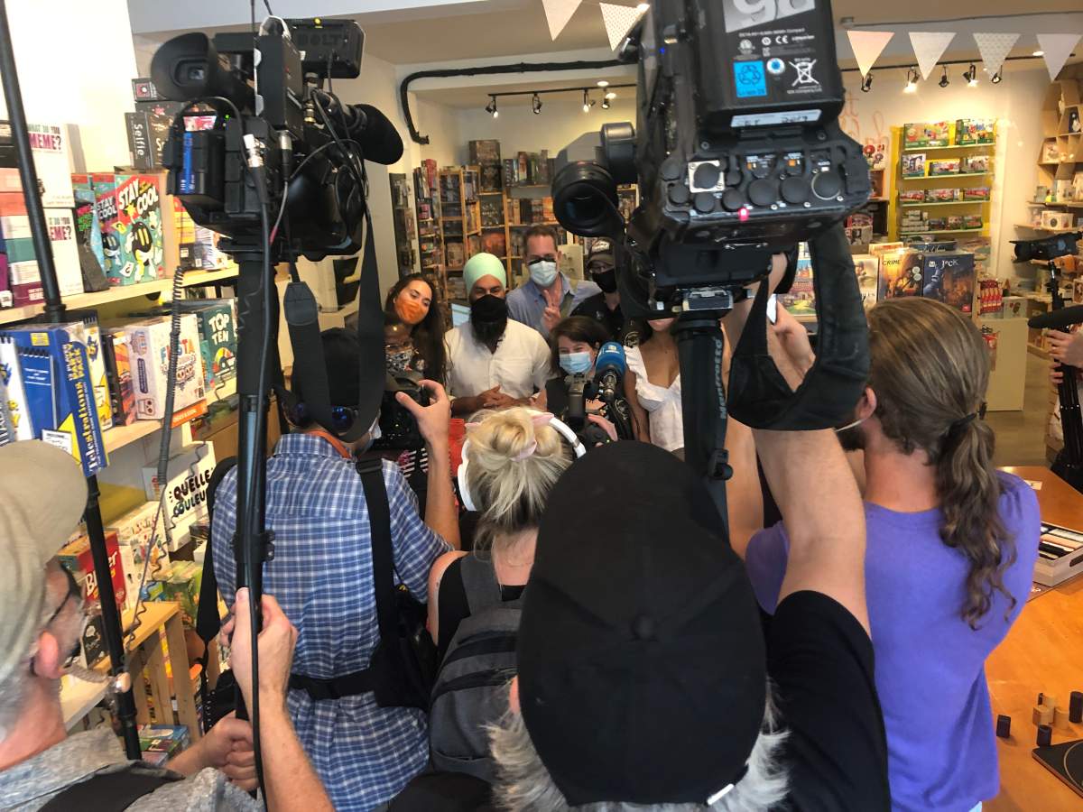 NDP Leader Jagmeet Singh and NDP incumbent candidate Alexandre Boulerice pose for media cameras on Monday, August 23, 2021 in Boutique Randolph, a toy shop in the Montreal riding of Papineau, the riding held by Liberal leader Justin Trudeau. (David Akin/Global News)