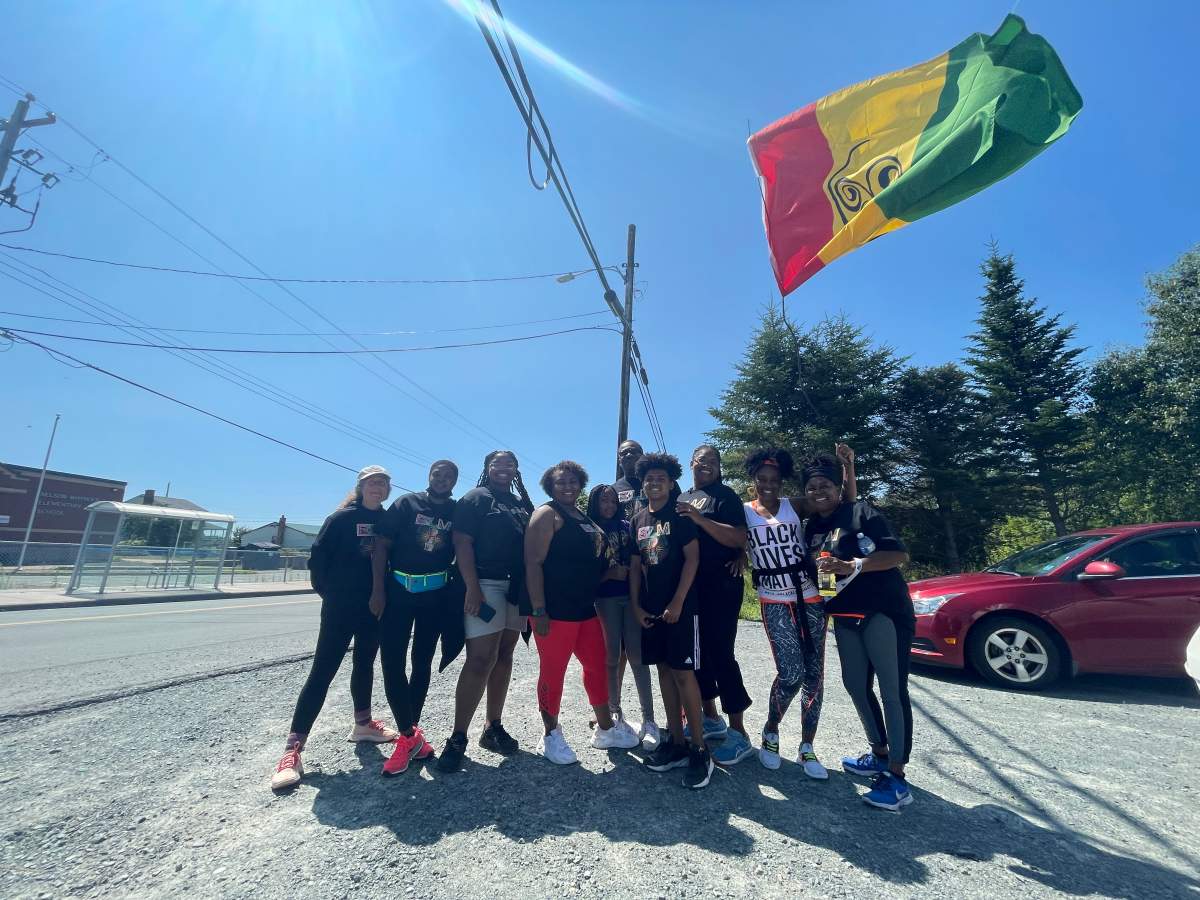Runners and walkers wave the African Nova Scotian flag high in North Preston.