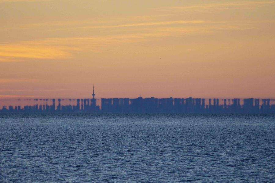 toronto skyline from across lake ontario distorted by mirage