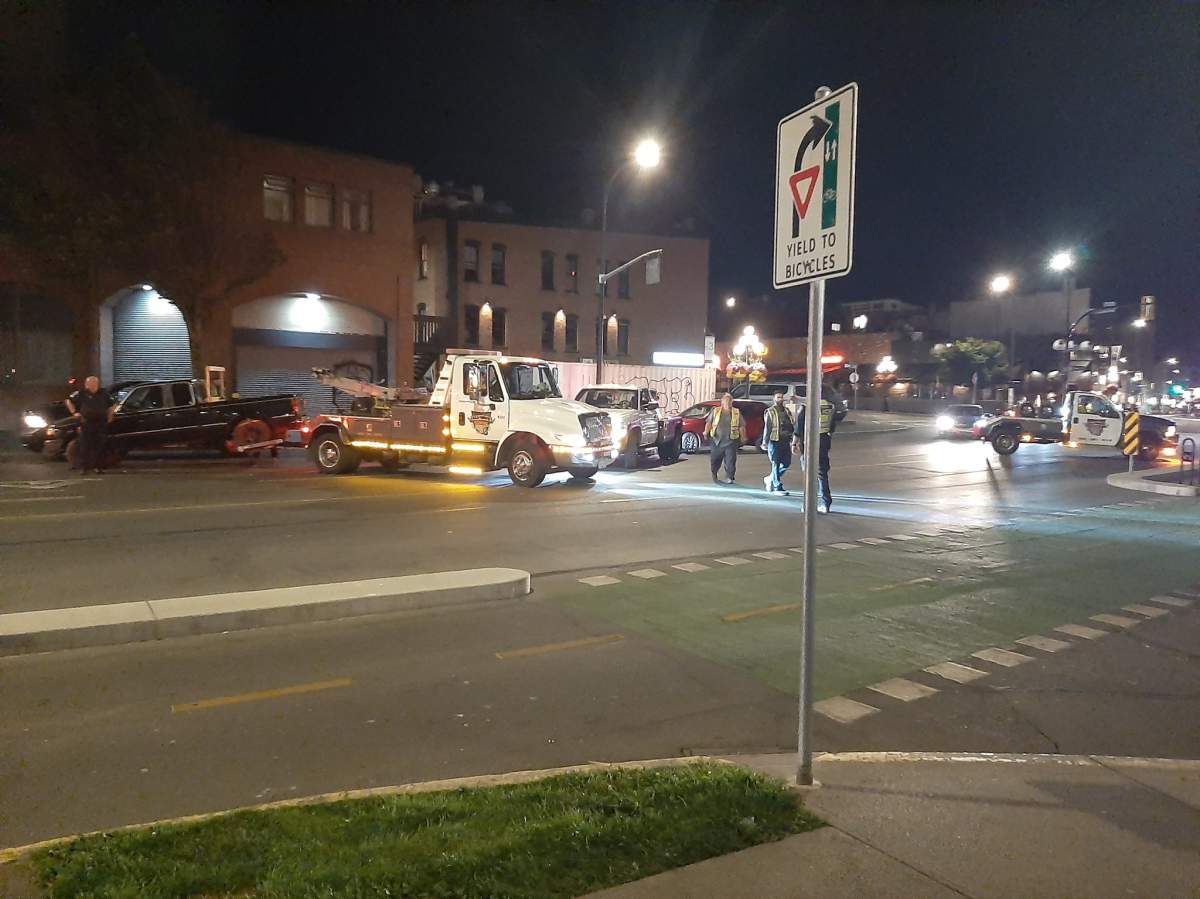 Victoria police at the scene of one of the roadblocks on July 31. A tow truck can be seen removing a vehicle from the scene.