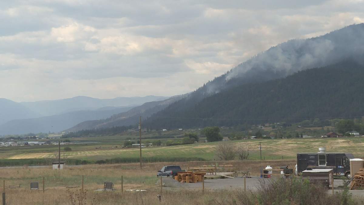 Smoke rises from the White Rock Lake fire, above Westside Road, on Thursday, August 19. 