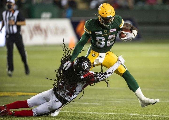 Ottawa Redblacks' Abdul Kanneh (14) tackles Edmonton Elks' James Wilder Jr. (32) during second half CFL action in Edmonton, Alta., on Saturday August 7, 2021. 