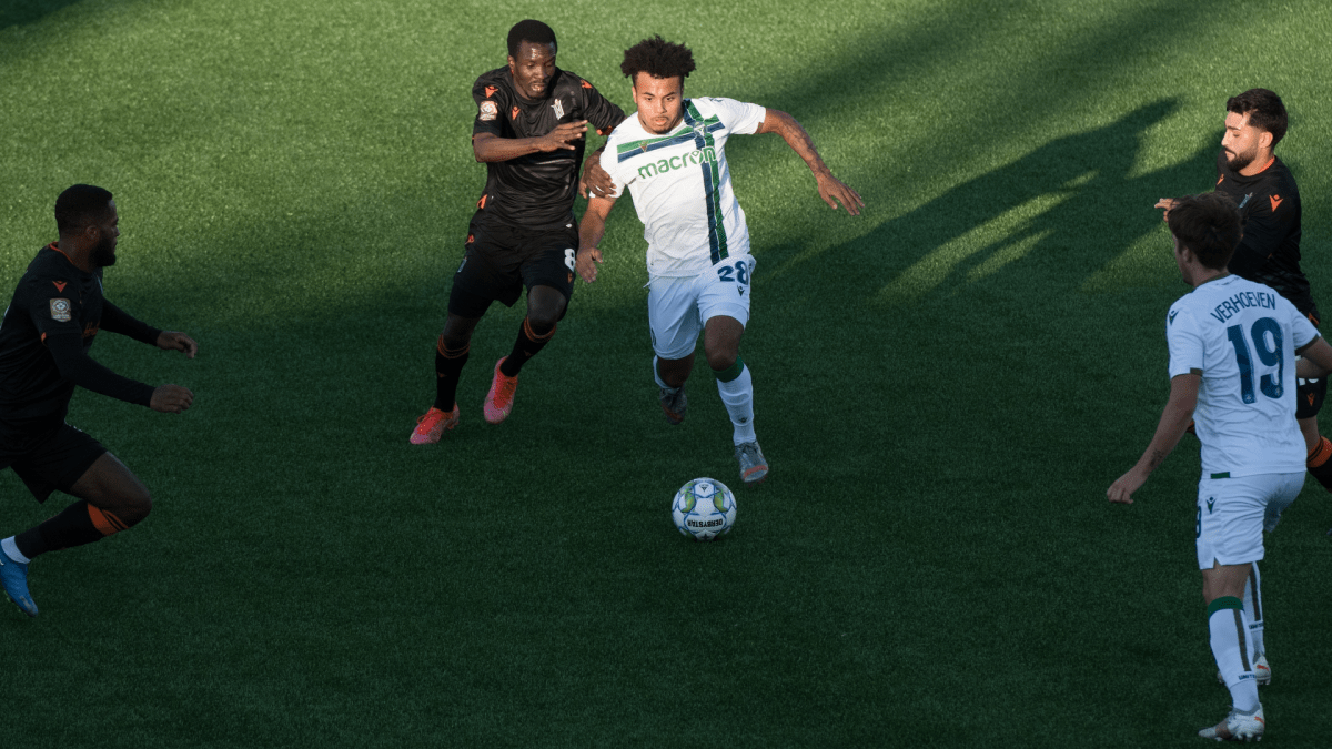 Cedric Toussaint of York United FC moves past Elimane Oumar Cisse of Forge Hamilton FC during CPL soccer action at York Lions Stadium in Toronto on Friday, July 30, 2021. THE CANADIAN PRESS/ Tijana Martin .