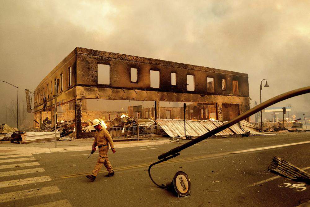Operations Chief Jay Walter passes the historic Sierra Lodge as the Dixie Fire burns through the Greenville community of Plumas County, Calif., on Wednesday, Aug. 4, 2021. The fire leveled multiple historic buildings and dozens of homes in central Greenville.