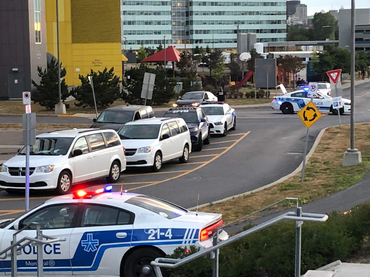 A heavy police presence is seen outside the McGill University Health Centre on Tuesday, Aug. 24, 2021.