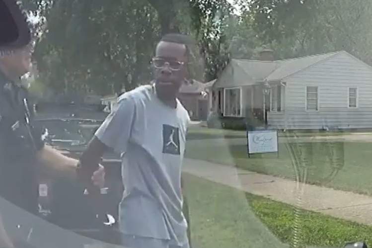 Police handcuff realtor Eric D. Brown outside a home he was showing to clients in Wyoming, Mich., on Aug. 1, 2021.