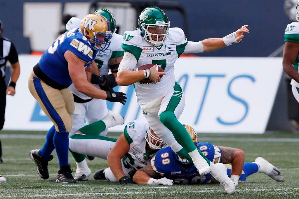 Saskatchewan Roughriders quarterback Cody Fajardo (7) scrambles for the first down during the first half of CFL action against the Winnipeg Blue Bombers in Winnipeg, Sept. 11, 2021.