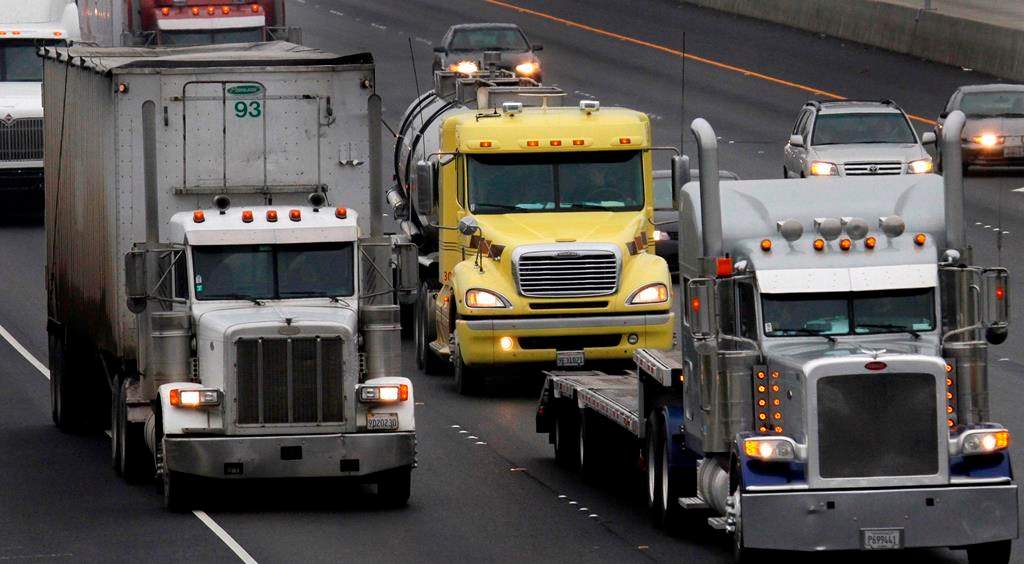 File photo of semi-tractor trailers on a highway.