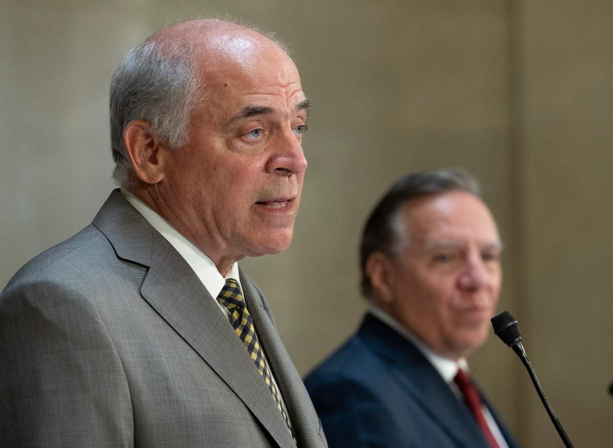 Quebec Economy and Innovation Minister Pierre Fitzgibbon responds to reporters questions as Quebec Premier Francois Legault, right, looks on during a news conference on Wednesday, September 1, 2021 at the legislature in Quebec City. 
