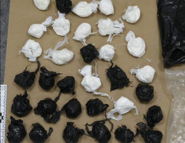 After the suspicious man was seen stashing the packages, a homeowner contacted police, who were able to determine that the bags contained a large amount of suspected cocaine.