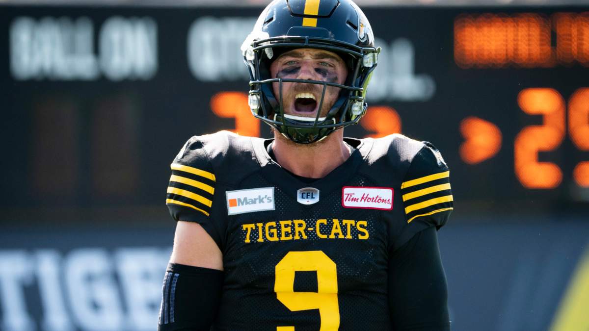 Hamilton Tiger Cats quarterback Dane Evans (9) celebrates his touchdown pass to Hamilton Tiger Cats wide receiver Jaelon Acklin (80) during second half CFL football game action against the Toronto Argonauts in Hamilton, Ont., Monday, Sept. 6, 2021. THE CANADIAN PRESS/Peter Power .