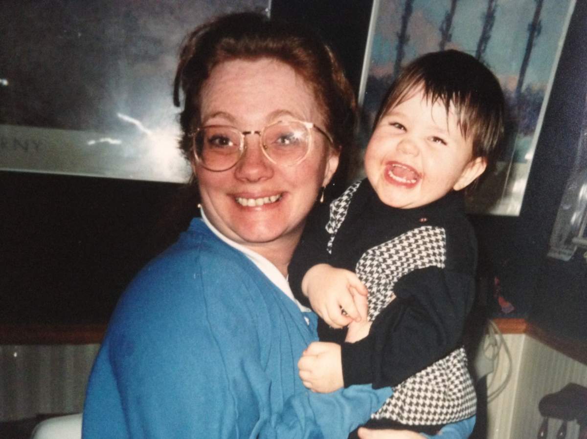 Julia Ferguson as a child being held by her mother.