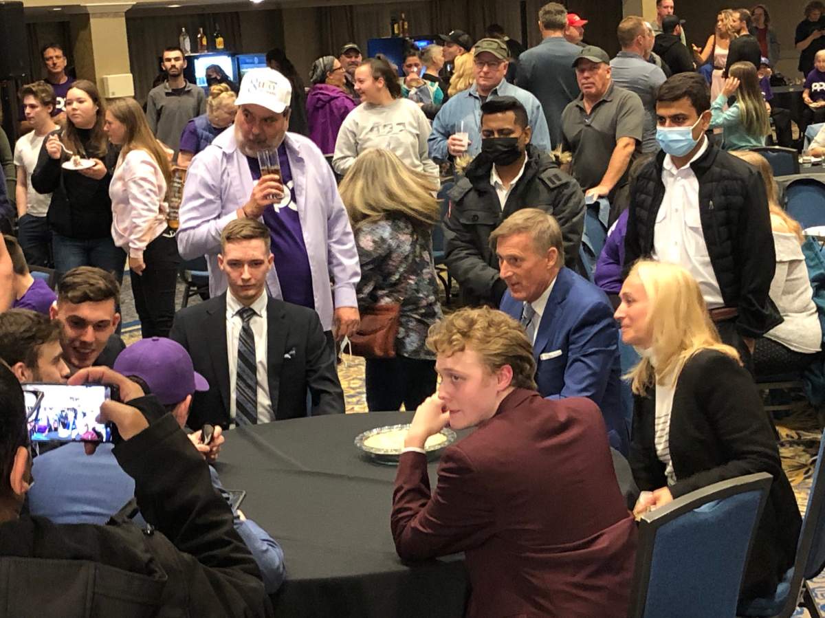One photo from the PPC event shows PPC Leader Maxime Bernier sitting maskless at a table surrounded by supporters, most of who are not wearing masks.