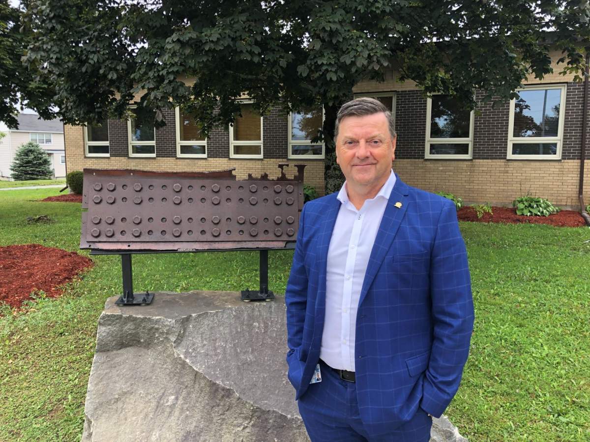 Percy Farwell, mayor of Gander, N.L., stands next to a chunk of steel from the World Trade Centre, a permanent reminder of the terrorist attacks of 9/11.
