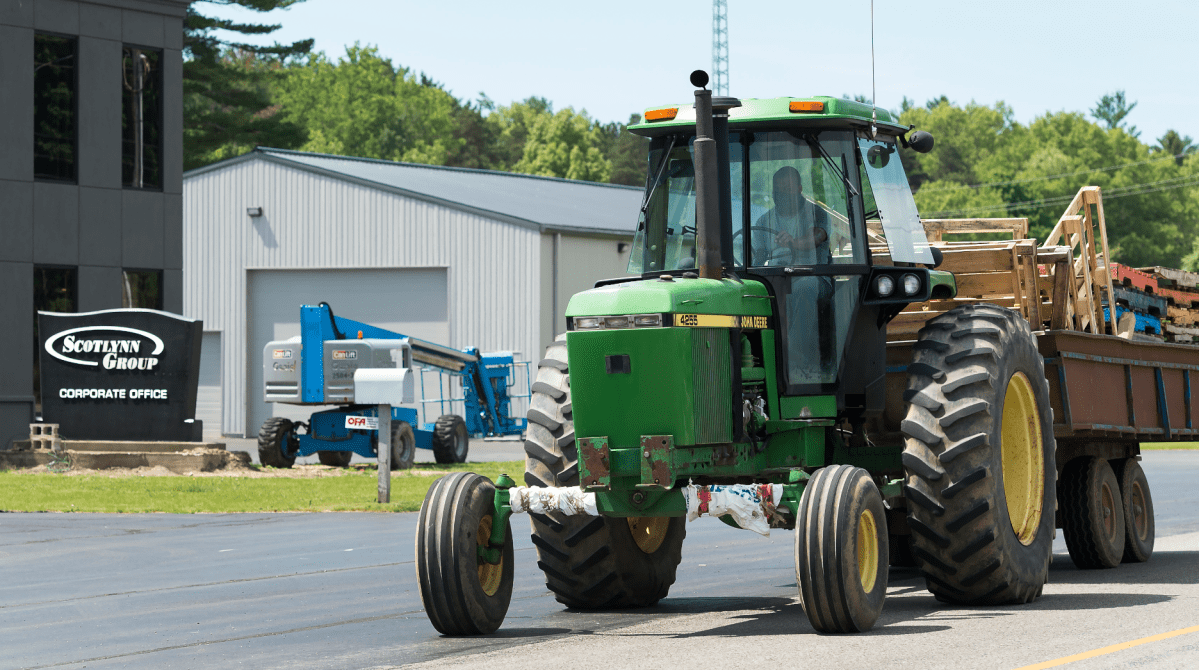 A tractor drives past the main office at the Scotlynn Group where 164 Migrant workers have tested positive for COVID-19 shutting down the asparagus farming facility temporarily during the COVID-19 pandemic near Vittoria, Ont., in Norfolk County on Wednesday, June 3, 2020. THE CANADIAN PRESS/Nathan Denette .
