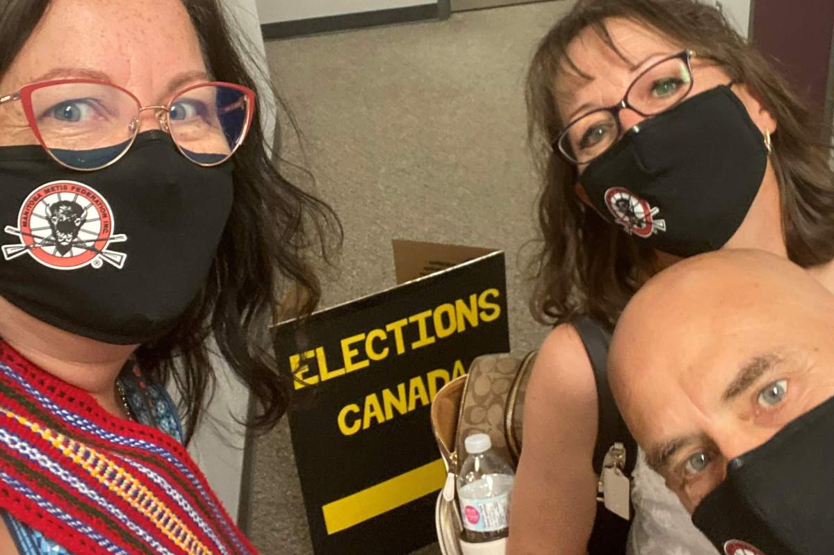 Sharon Parenteau (left) and her colleagues at the Manitoba Métis Federation cast their advance ballots on Fri.  Sept. 10, 2021 in Winnipeg.