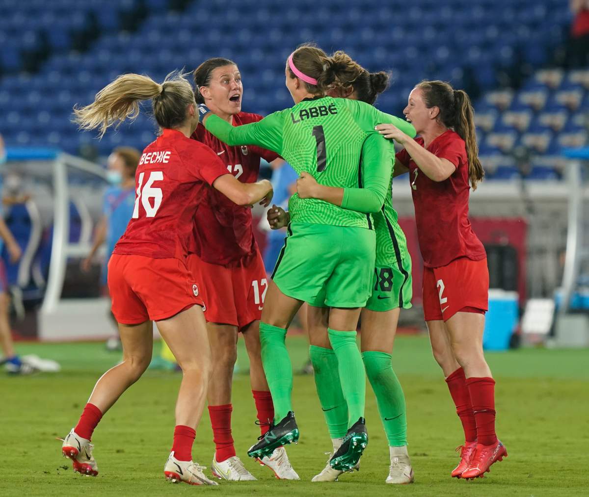 Canada players celebrate their win against Sweden with keeper Stephanie Labbe during the women’s soccer gold medal game at the Tokyo Olympics in Yokohama, Japan on Friday, August 6, 2021.