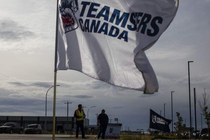 Organizers from Teamsters Local Union 362 rally outside an Amazon facility to get support and distribute information to Amazon workers, in Nisku, Alta, on Tuesday, September 14, 2021.