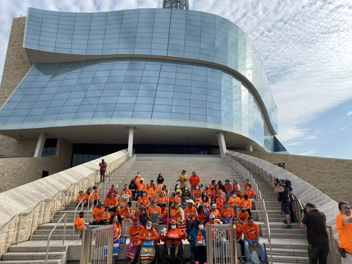 Residential school survivors sit on the steps of the Canadian Museum for Human Rights on the first National Day for Truth and Reconciliation.
