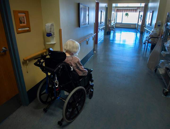 A resident makes her way down a hallway at CHSLD Rose-de-Lima seniors residence Friday, March 12, 2021 in Laval, Quebec. 