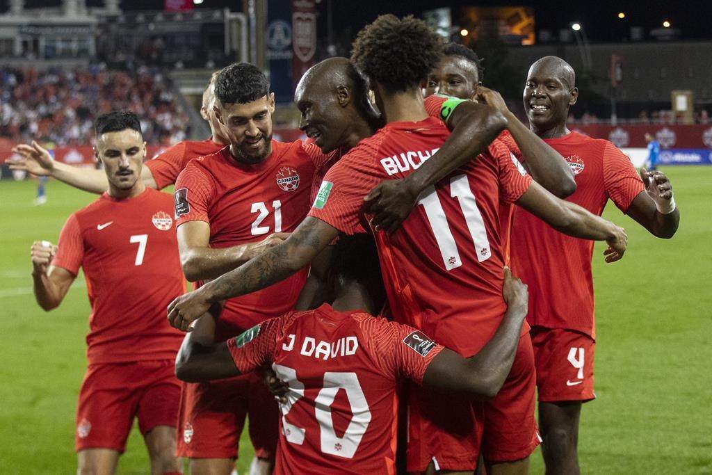 FILE: Canada's captain Atiba Hutchinson stands in the centre of the celebrations as the team celebrates their third goal against El Salvador during second half World Cup qualifying action in Toronto, Wednesday, Sept. 8, 2021. 