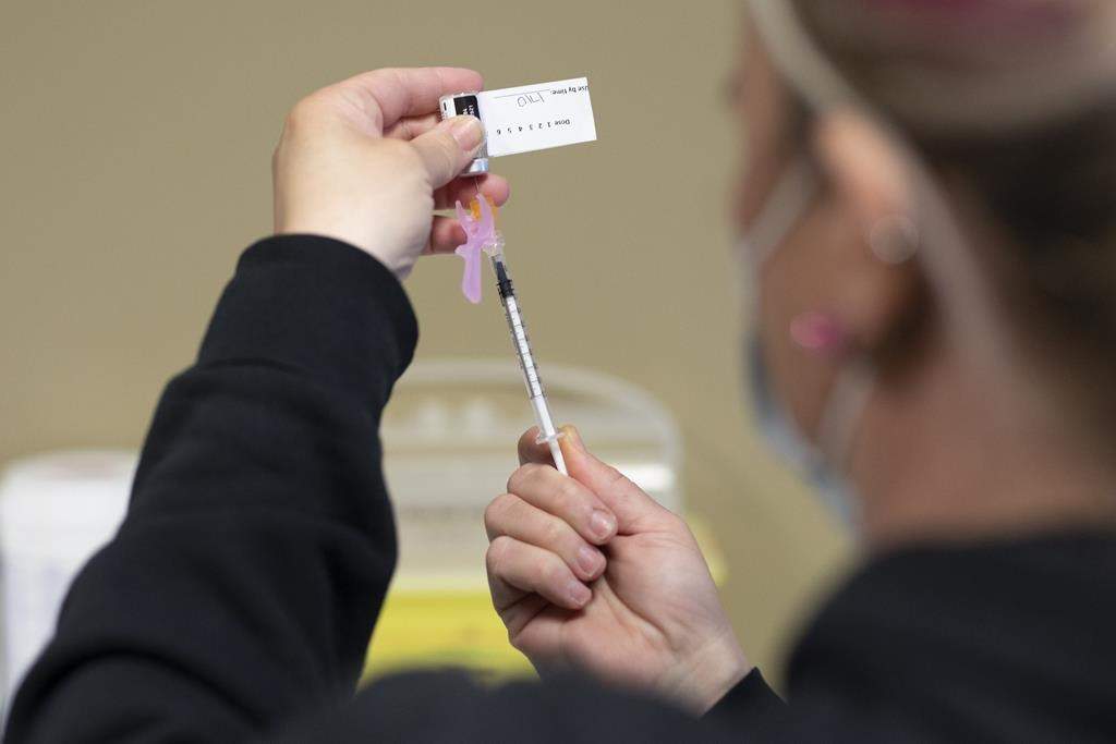 A RN draws the vaccine into a syringe at the Saskatoon Tribal Council run vaccination clinic inside SaskTel Centre on April 15, 2021.