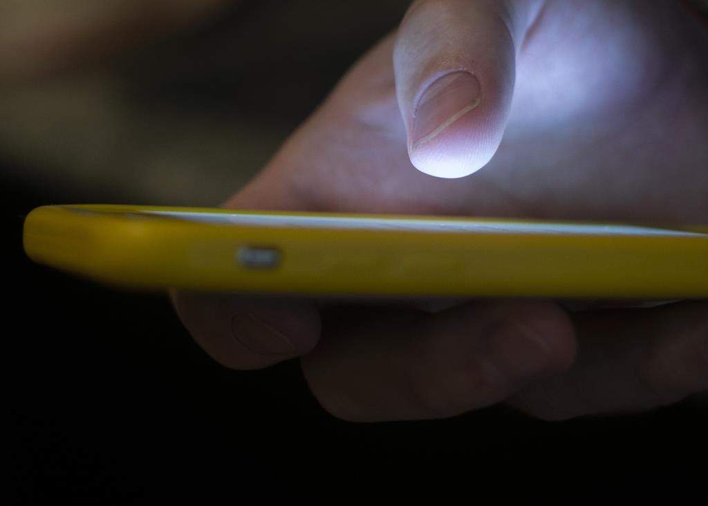 FILE - In this Aug. 11, 2019, file photo, a cellphone is used.