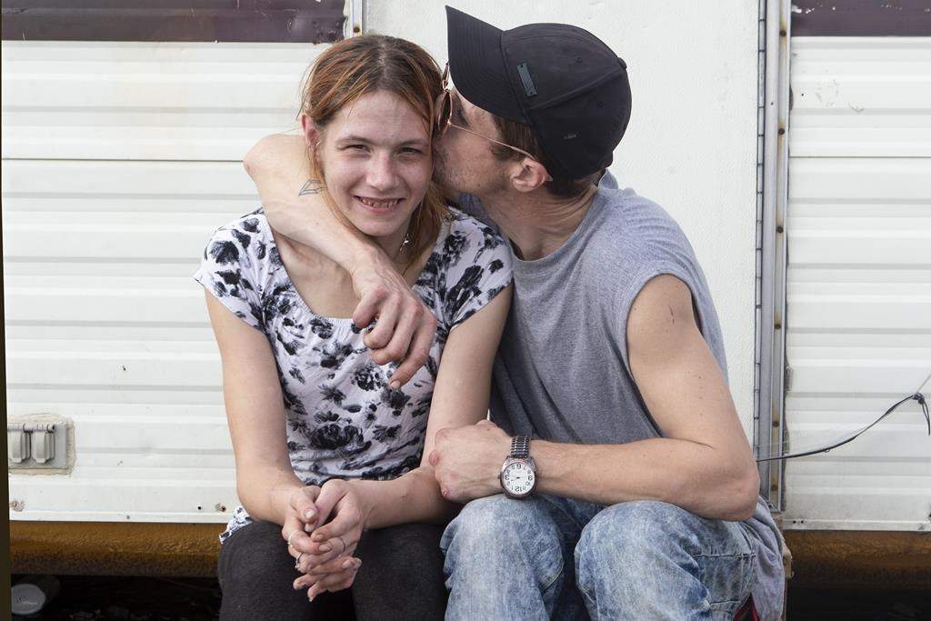 Tim Wel and Bree Cooper are pictured in the "A Better Tent City," community in Kitchener, Ont., on Thursday, October 14, 2021. The community provides small cabins set up as an alternative to the homeless shelter system in the area.