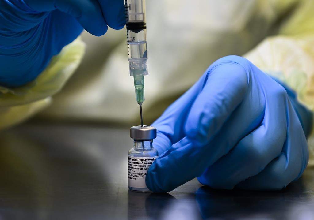 A health-care worker prepares a dose of the Pfizer-BioNTech COVID-19 vaccine at a UHN COVID-19 vaccine clinic in Toronto on Thursday, January 7, 2021.THE CANADIAN PRESS/Nathan Denette.