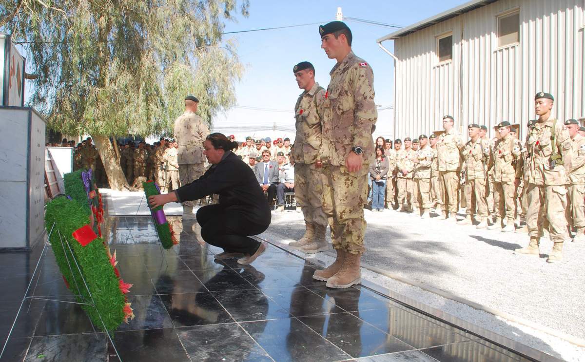 Josee Simard, whose daughter Cpl. Karine Blais was killed in Afghanistan on April 13, 2009, lays a wreath during a Remembrance Day ceremony at Kandahar Airfield, Afghanistan Thursday Nov. 11, 2010. THE CANADIAN PRESS/ Jonathan Montpetit