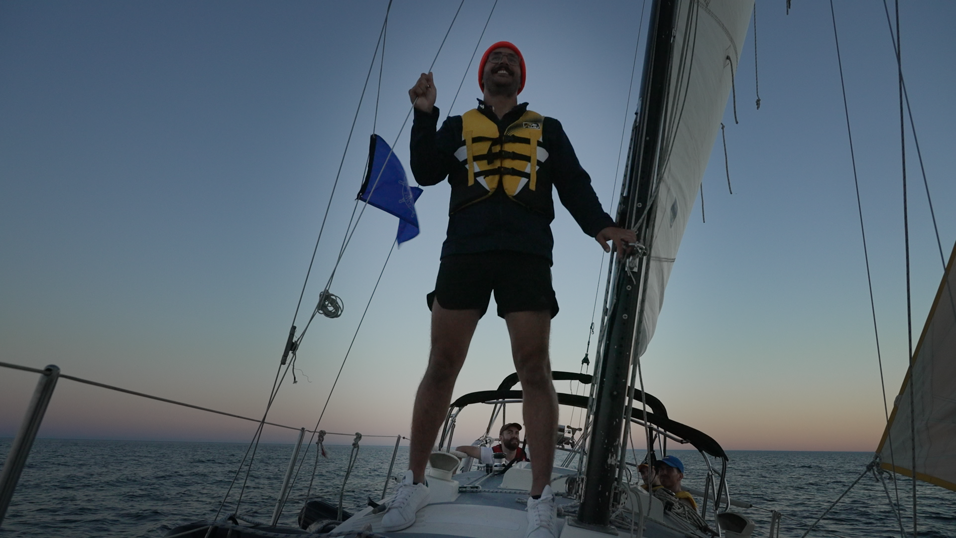 William Mansur stands on his boat while sailing on Lake Ontario