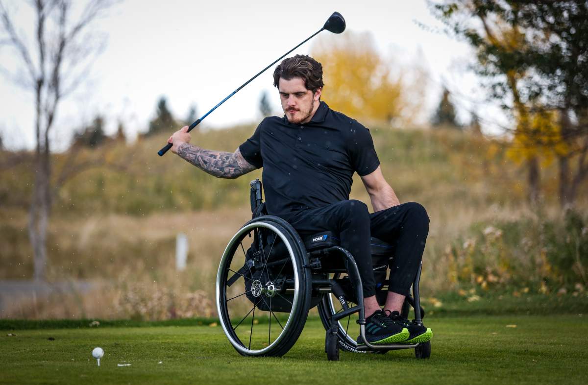 Humboldt Broncos bus crash survivor Ryan Straschnitzki hits a golf ball during a paragolf lesson in Calgary, Alta., Tuesday, Sept. 28, 2021.