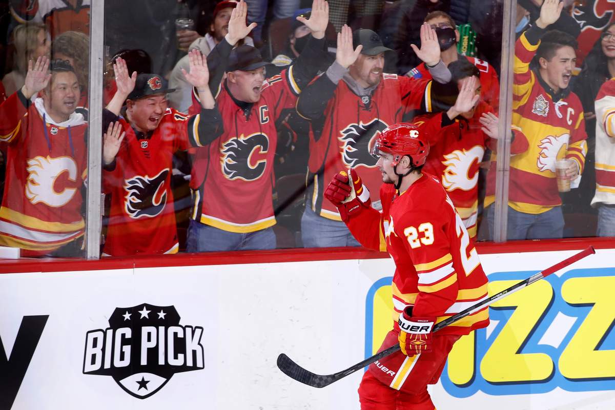 Calgary Flames’ Sean Monahan celebrates his goal against the Philadelphia Flyers with fans during second period NHL hockey action in Calgary, Saturday, Oct. 30, 2021.