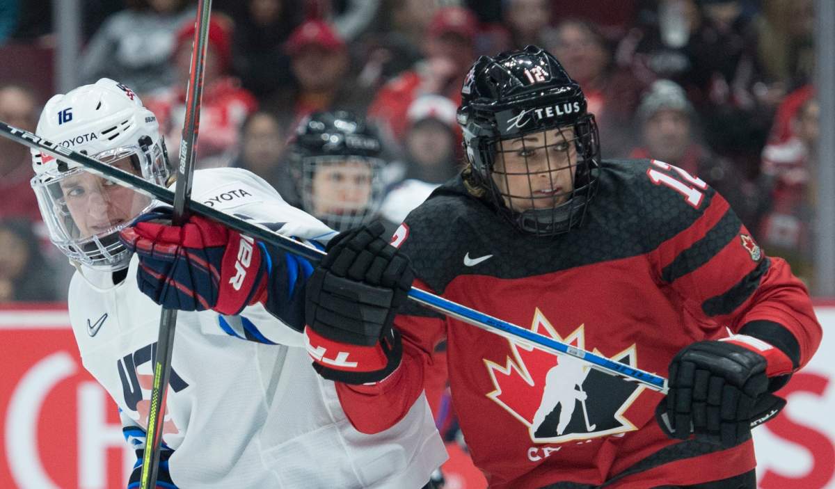 Team Canada's Meaghan Mikkelson fights for control of the puck with U.S.A.'s Hayley Scamurra during third period of Women's Rivalry Series hockey action in Vancouver, Wednesday, February 5, 2020. 