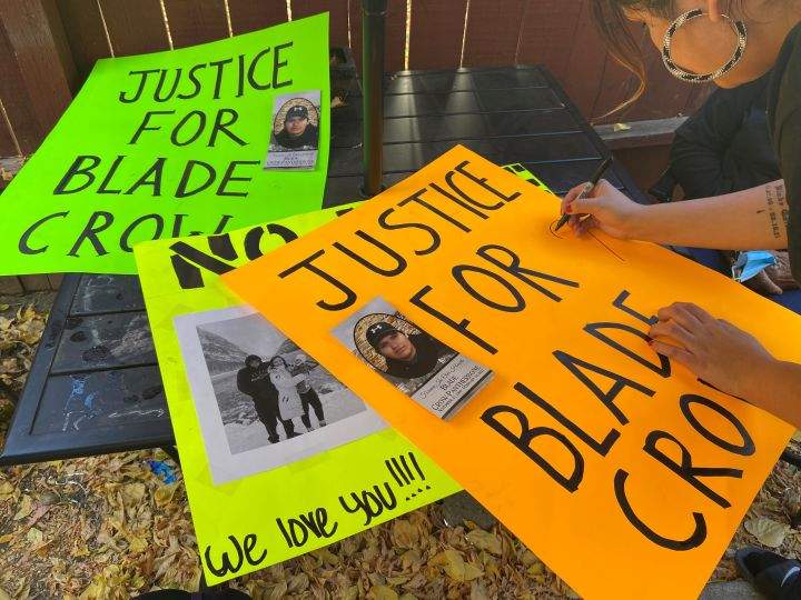Signs call for justice for Blade Crow Pantherbone, who was killed in a hit-and-run crash in Calgary.